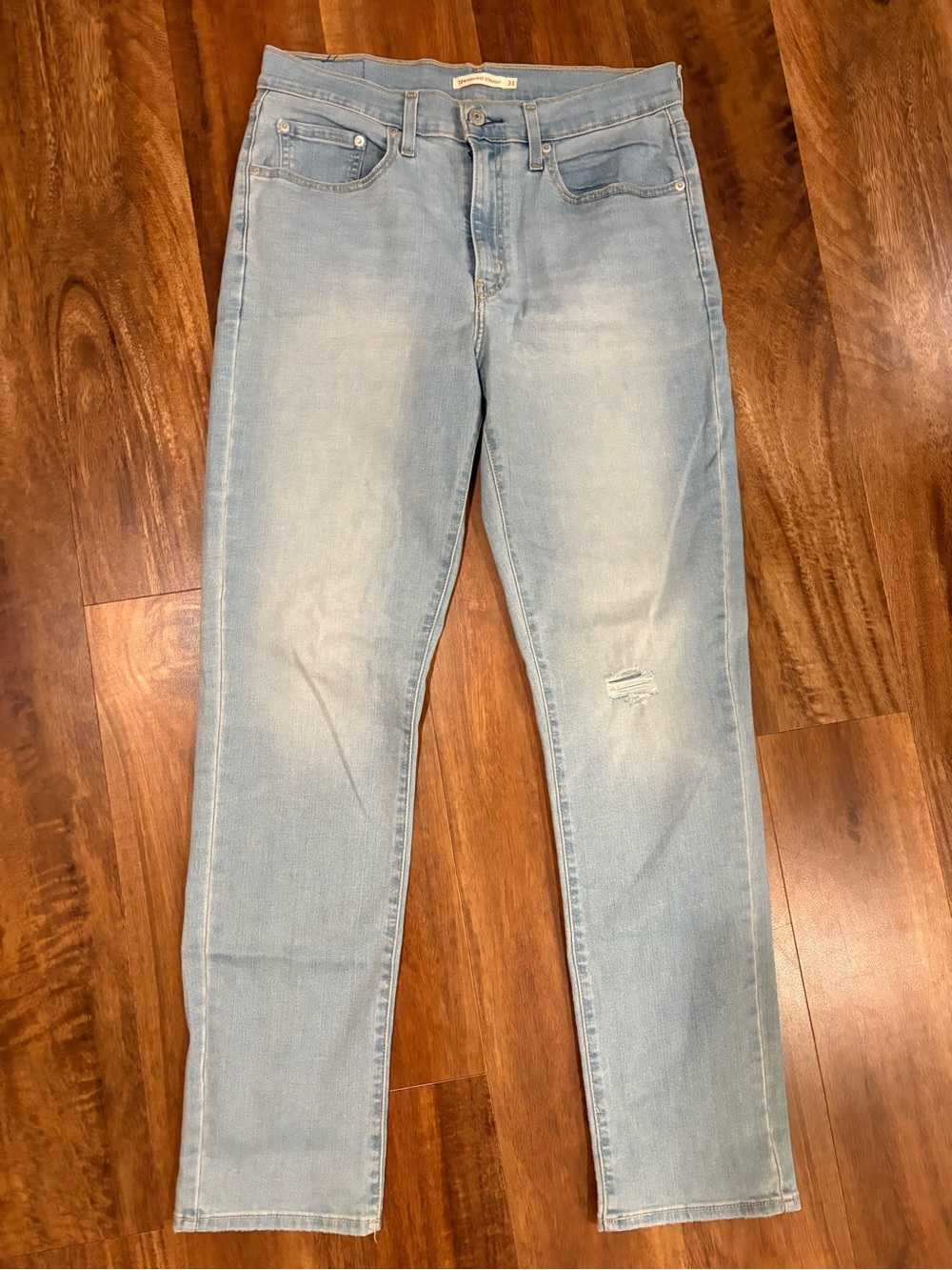 Levi's 724 High Rise Straight light wash jeans. Lightly distressed. Size 31